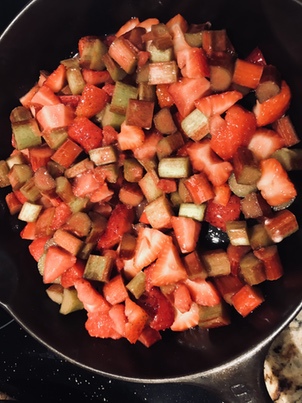 Strawberries and rhubarb cooking in a vintage Griswold cast iron skillet number 6.