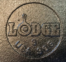 Lodge "egg in skillet" logo on bottom of griddle. 