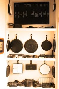 Some of Grady Britt's vintage Griswold cast iron cookware, including the loaf pan, Quaker Ware, and heart star waffle iron. 