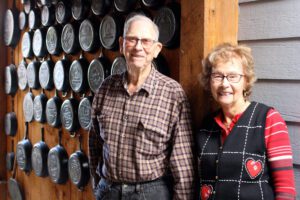 Larry and Marg O'Neil of Tacoma WA with vintage Lodge commemorative and advertising cast iron skillets to the side.