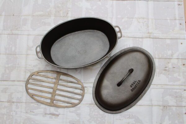 Vintage Cast Iron Unmarked Lodge Oval Roaster No. 4 with Trivet and Lid Cover collection of john clough