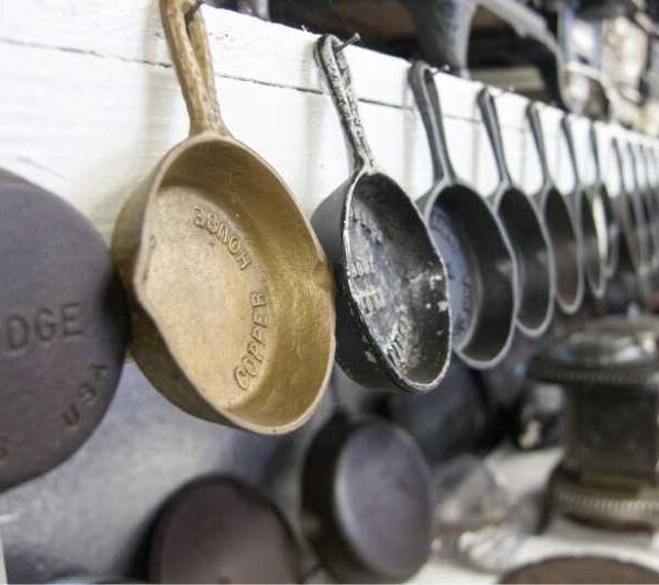 Small Antique and Vintage Cast Iron Skillets handing in the O'Neil Cast Iron Museum in Tacoma Washington