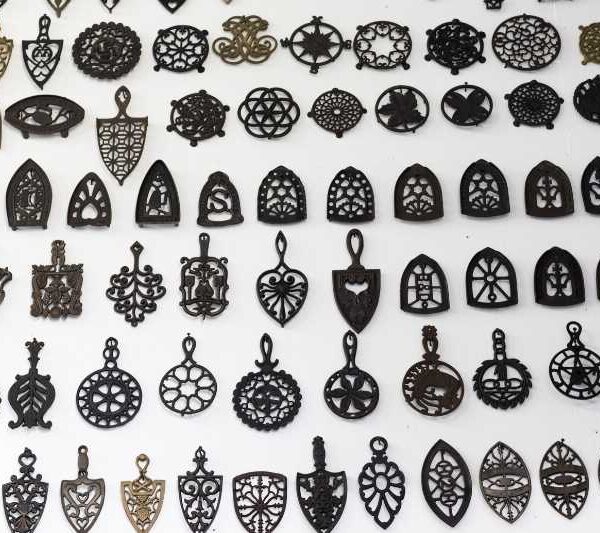 Wall of Antique and Vintage Cast Iron Trivets and Sad Iron Trivets in the O'Neil Cast Iron Museum