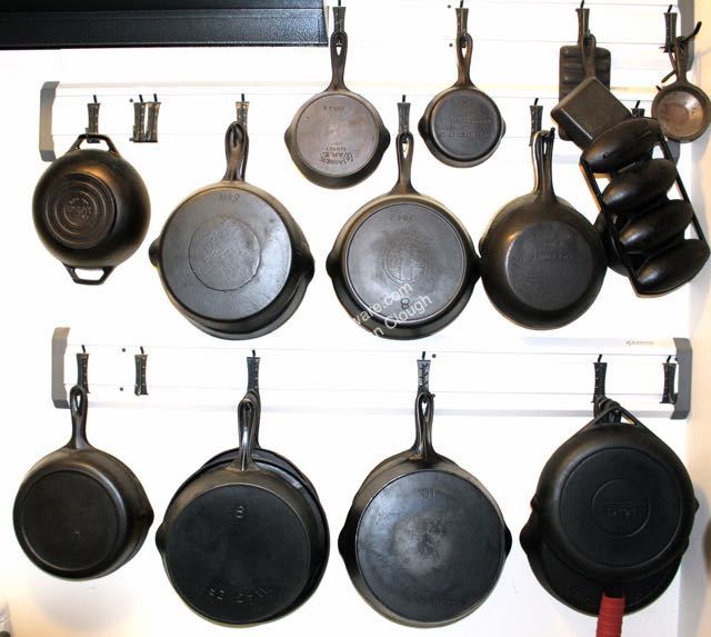 John Clough kitchen display of antique and vintage cast iron cookware including Wagner and Lodge. 
