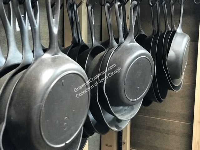 John Clough collection of vintage and antique Lodge cast iron skillets including no notch, one notch, and three notch frying pans