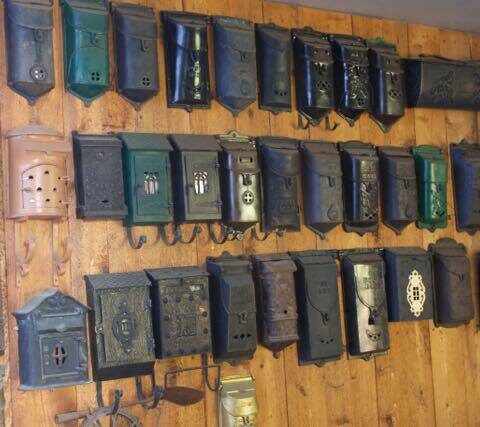 Vintage and Antique Cast Iron Mailboxes on a wall at the O'Neil Home mail box collect collection collector