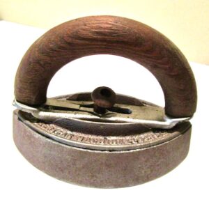 Example of a cast iron sad iron with wood handle. 