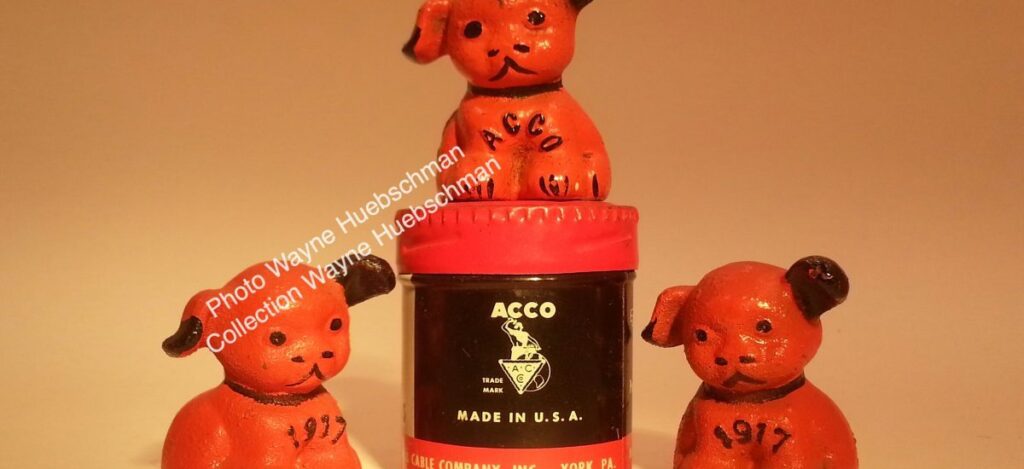 Vintage orange and black ACCO and 1917 cast iron pup with Hines ghost mark on its rump. 