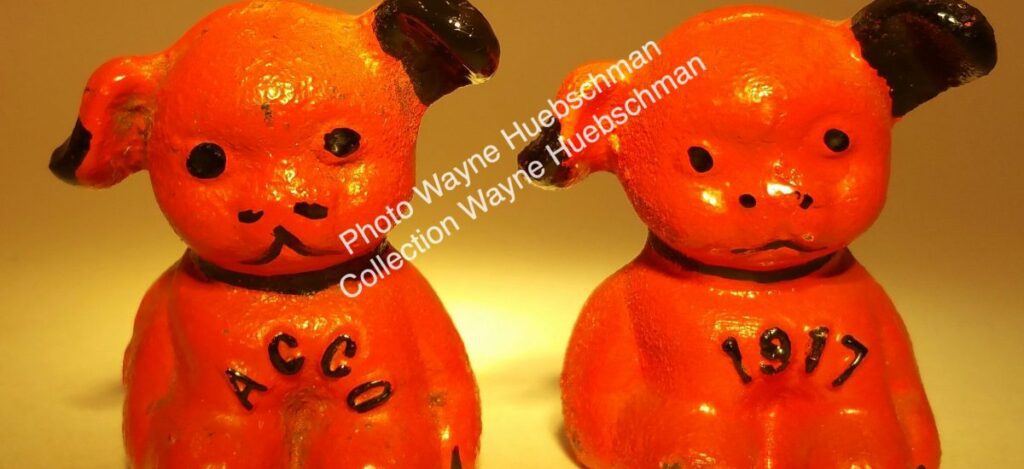 Vintage orange and black ACCO and 1917 cast iron pup with Hines ghost mark on its rump. 