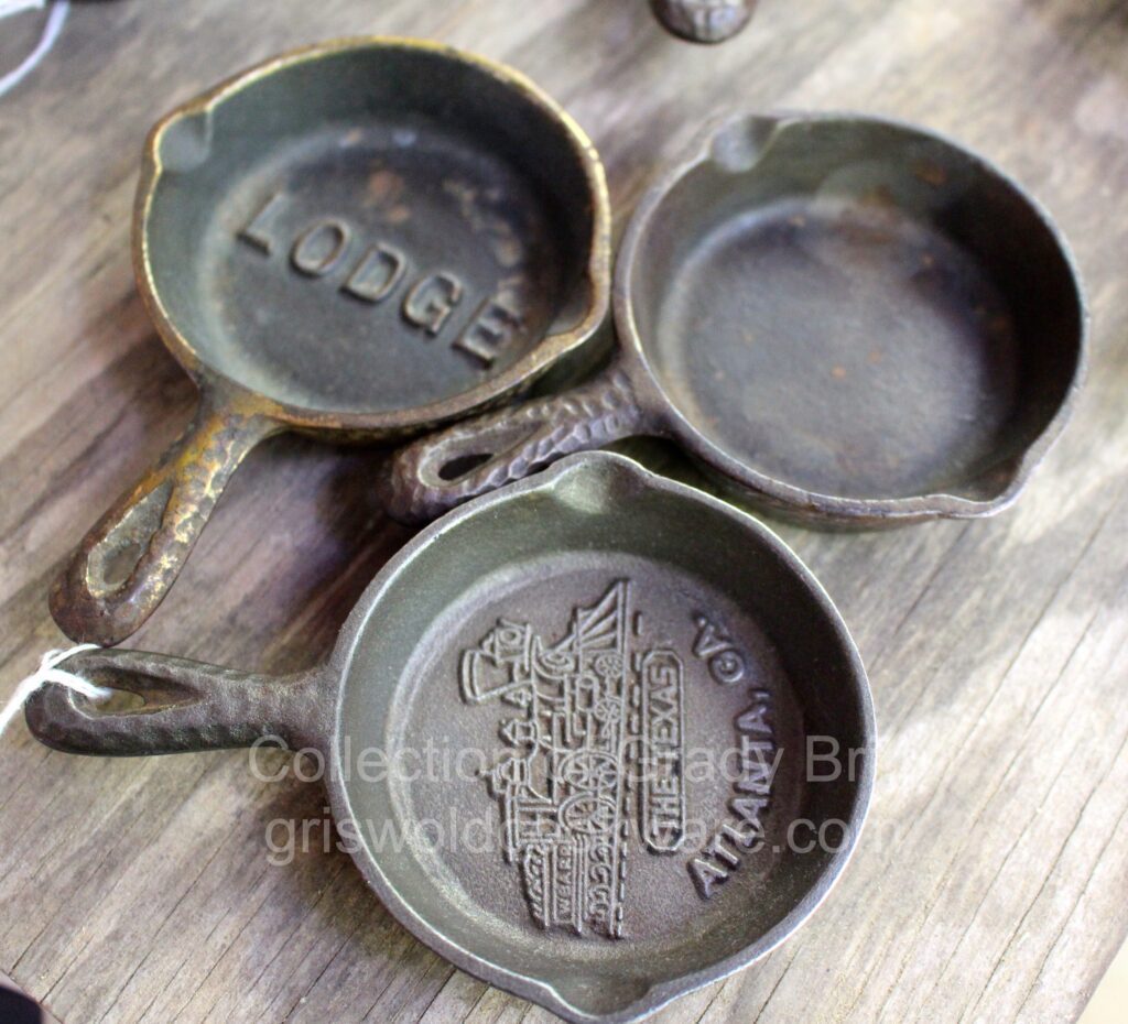 Miniature vintage cast iron ashtrays made by Lodge with different advertisers. From the collection of Grady Britt. 