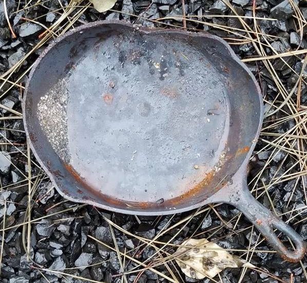 Vintage Wagner Ware cast iron pan with flaking and fire damage