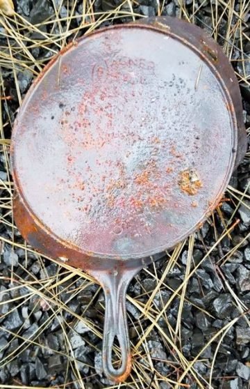 Vintage Wagner Ware cast iron pan with flaking and fire damage