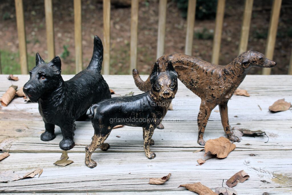 Antique vintage cast iron Lodge Boston Terrier Wolf Hound and Scottie Dog ornamental door stops from the collection of Grady Britt.