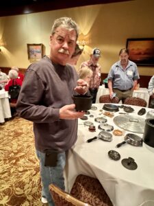 Scott McCarter at griswold cast iron cookware convention showing antique rare piece