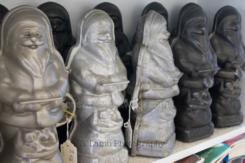 Some of Larry's Griswold Santa cake molds, all different