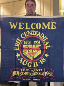 Vintage Griswold cast iron Collector Eric McAllister holding a pennant from the 1951 Erie County Centennial. 