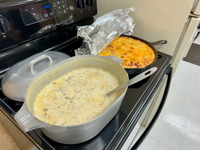 Sausage gravy in Magnalite roaster and egg casserole in large Griswold cast iron skillet. 