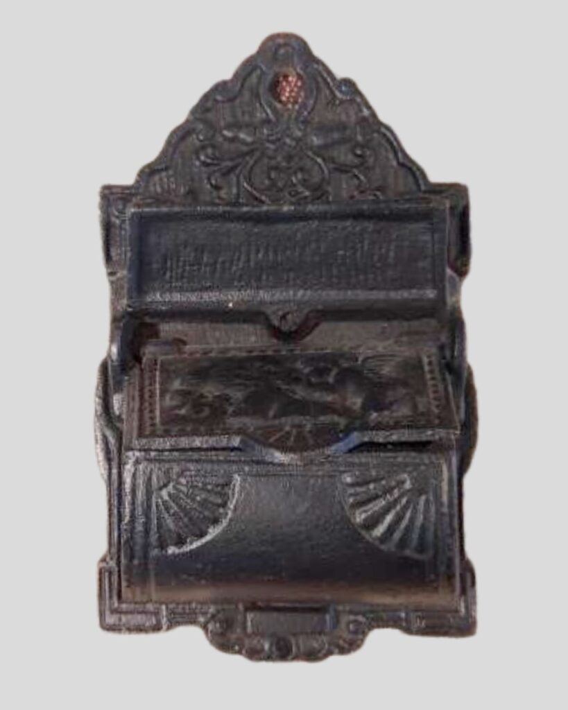 Vintage cast iron match holder or keeper with lid raised to show container area.