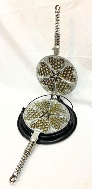 Plated Griswold cast iron heart and star waffle iron. 
