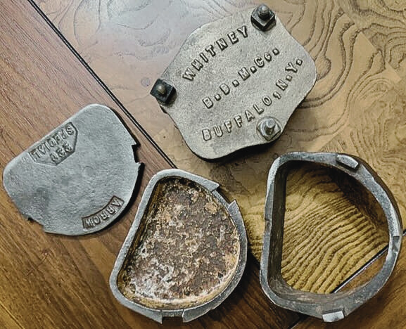 Two antique cast iron dental molds, separated into four pieces. 