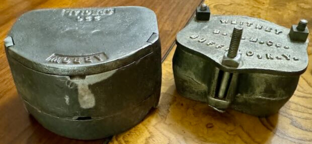 Two antique cast iron dental molds. 