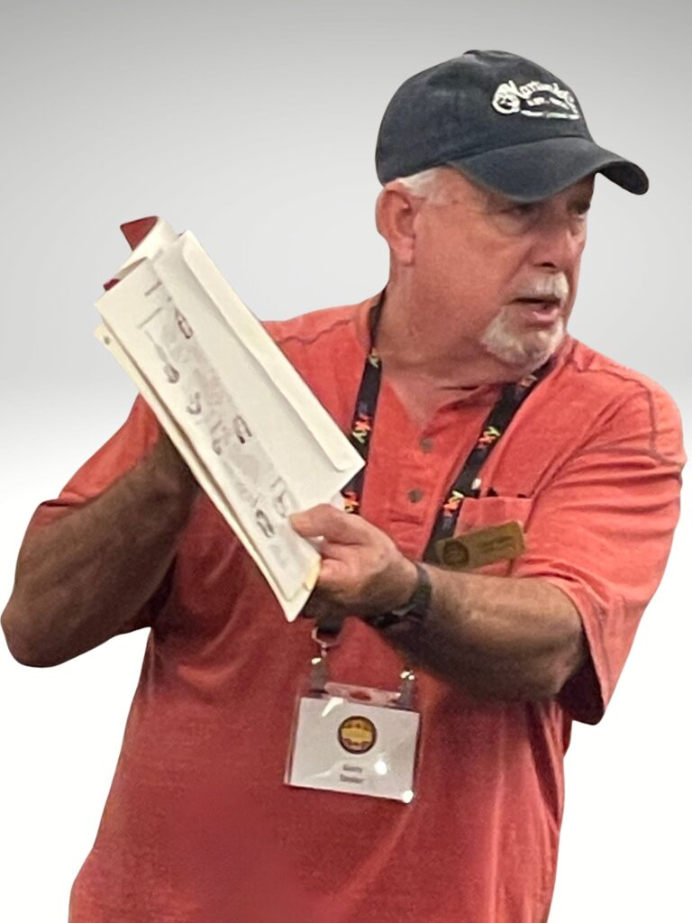 Gary Taylor holding a cast iron collector's book at the cast iron convention. 