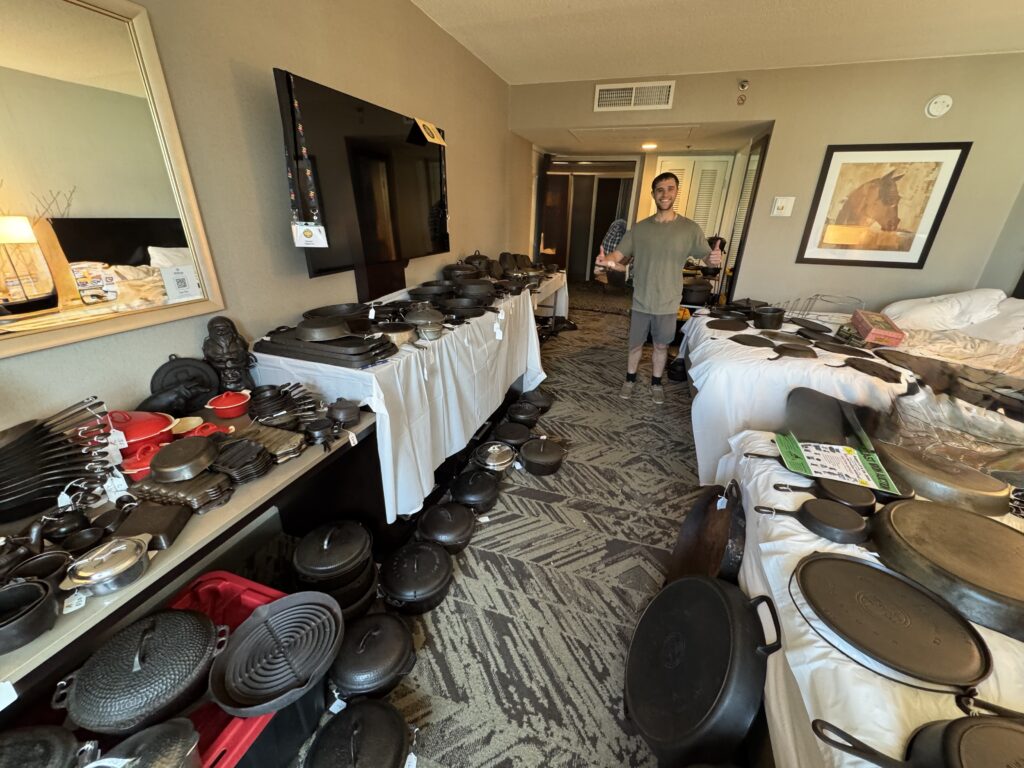 Gunner Hagstrom in hotel room at the cast iron convention with many pieces of cast iron for sale. 